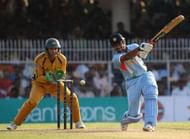 NAGPUR, INDIA - OCTOBER 14: Robin Uthappa of India hits to mid off with Adam Gilchrist of Australia looking on during the sixth one day international match between India and Australia at at the VCA Stadium on October 14, 2007 in Nagpur, India. (Photo by Hamish Blair/Getty Images)